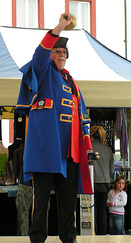 Little girls wonders what town crier is doing