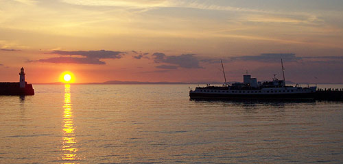 Balmoral with sunset as people leave the ship