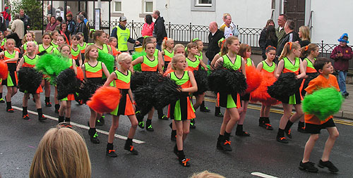 Starkey's pom pom dancers in black green and orange