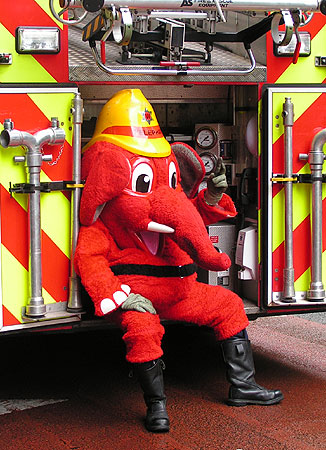 Welephant sitting on fire engine