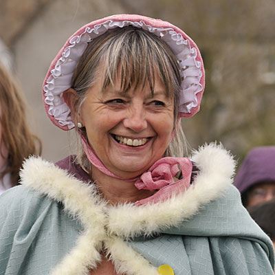 smiling lady fur trimmed cloak