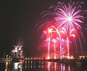 People on the quayside dwarfed by the huge fireworks