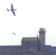 Spitfire over old lighthouse