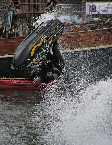 Jet ski somersault in front of tall ship Zebu