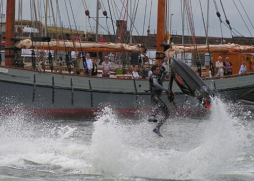 Jetski flying from the water in front of Tall Ship Irine