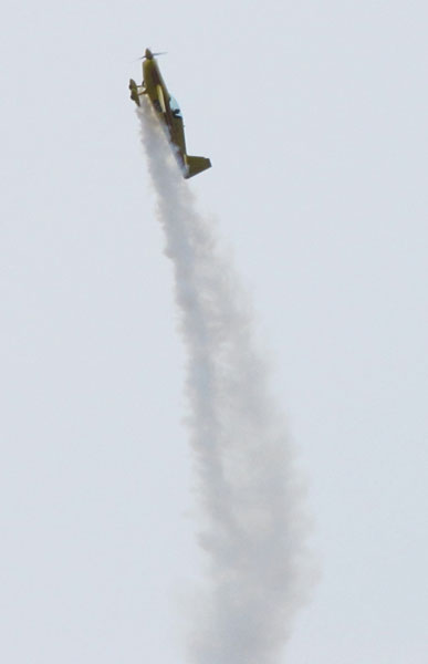 Extra 260 stunt plane in vertical climb