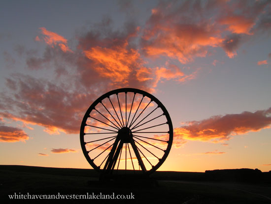 orange clouds behind pit wheel