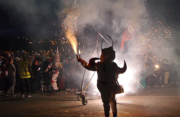 Devil with fireworks in the crowd